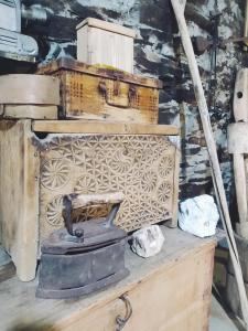 a painting of a room with a stove and boxes at Raul Lushnu Darbaz in Mestia +123 photos