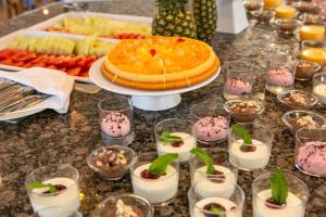 a table topped with a cake and a plate of food at RVHotels Nieves Mar in L'Escala