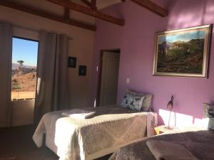 a bedroom with two beds and a window at The Stix in Dullstroom