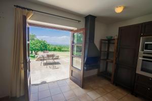 a room with a door open to a patio with a table at Can LLorens in Llagostera