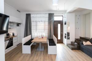 een keuken en een woonkamer met een tafel en een bank bij Apartma J.E.Ž. in Bohinj