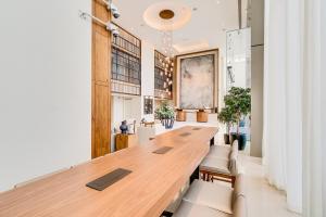 a long wooden table in a room with chairs at Vida Downtown Residences in Dubai