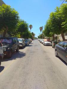 a street with cars parked on the side of the road at Iridas house in Kos Town
