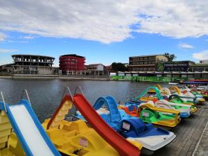 a row of colorful water slides in a river at Hotel Prestige Beach in Costinesti