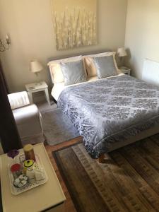 a bedroom with a bed and a coffee table at Lynburn Country Retreat in Biggar