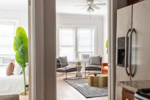 a kitchen with a living room with a couch and chairs at Lively 2BR Apt in Lincoln Square - Eastwood 47-1 in Chicago