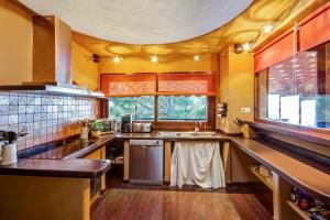 a large kitchen with yellow walls and wooden floors at Casa Blanca in Sant Miquel de Balansat