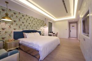 Postel nebo postele na pokoji v ubytování U-Her Hotel
