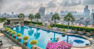 a swimming pool on the roof of a building with a city skyline at The Berkeley Hotel Pratunam in Bangkok