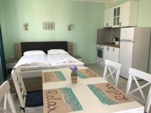 a room with a bed and a table and a kitchen at La MER 2 in Tsarevo