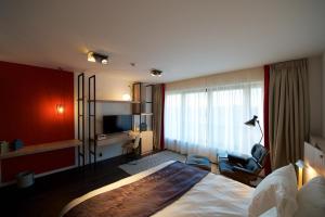 a hotel room with a bed and a television at OFF in Wavre