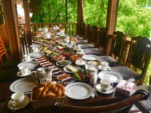 a long table filled with food and plates of food at Casanova Inn - Boutique Hotel in Dilijan