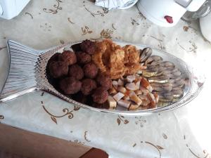 a plate of food with meatballs and other foods at Casa Nelu Pescaru in Mahmudia