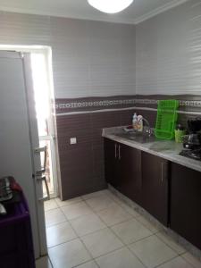 a kitchen with a sink and a counter top at Appartement meublé sécurisé in Agadir