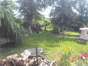 a garden with a fountain in the grass at Touch of Spain in Rural France in Darnac