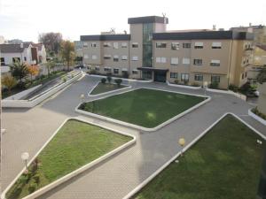 an empty courtyard in a building with grass at Comfortable & central apartment in Senhora da Hora