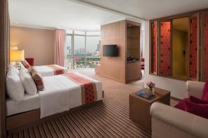a hotel room with a bed and a television at The Berkeley Hotel Pratunam - SHA Extra Plus in Bangkok
