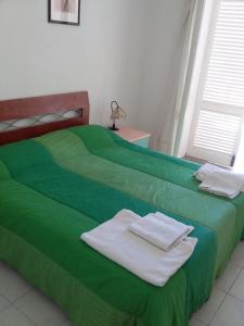 Łóżko lub łóżka w pokoju w obiekcie trilocale "Salina" e monolocale "Panarea" in Portorosa