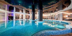 a large swimming pool in a building at Krumers Alpin – Your Mountain Oasis in Seefeld in Tirol