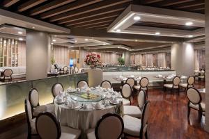 a banquet hall with tables and chairs in a room at The Berkeley Hotel Pratunam in Bangkok