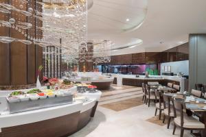 a rendering of a restaurant with tables and chairs at The Berkeley Hotel Pratunam in Bangkok