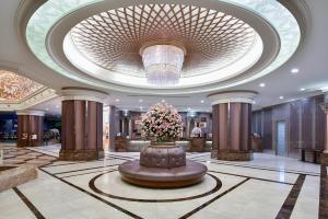 a lobby with a large ceiling with a large flower arrangement at The Berkeley Hotel Pratunam in Bangkok