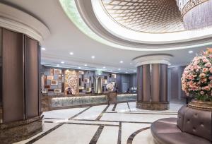 a lobby of a hotel with a large ceiling at The Berkeley Hotel Pratunam in Bangkok