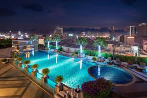 a swimming pool on the roof of a building at night at The Berkeley Hotel Pratunam in Bangkok