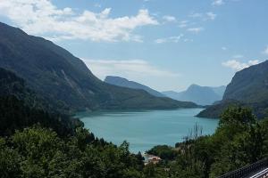 a view of a lake in a valley with mountains at Chalet La Perla Molveno in Molveno