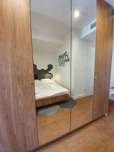 a mirror in a room with a bed in it at Prywatne apartamenty w hotelu - 365PAM in Sarbinowo