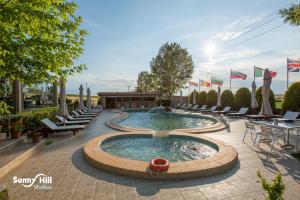 a pool with chairs and a table and a patio at Sunny Hill in Sani Beach +35 photos