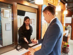 a man and a woman standing in front of a mirror at Hotel Hamby Resort in Chatan