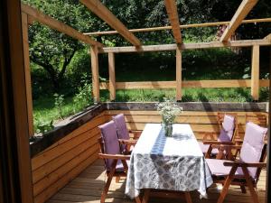 a patio with a table and chairs on a deck at Kellerstöckl am Sauerberg 20 in Moschendorf