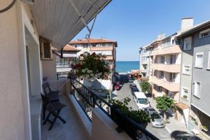 an apartment balcony with a view of the ocean at Tiffany Boutique Suits - Pomorie in Pomorie