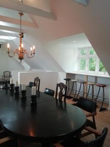 a dining room with a black table and chairs at LatterLy Apartments in Voel