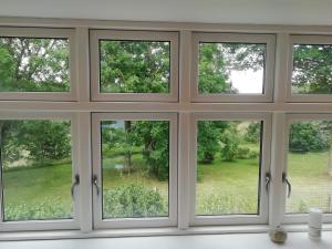 a room with four windows with a view of a yard at LatterLy Apartments in Voel