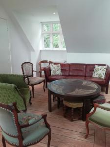 a living room with a couch and a table and chairs at LatterLy Apartments in Voel