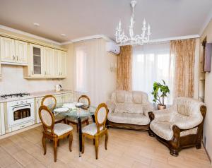 salon ze stołem i krzesłami w obiekcie Apart Reserve Sloboda Suite w Iwano-Frankiwsku