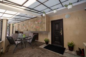 a room with a table and chairs and a fireplace at Tiffany Boutique Suits - Pomorie in Pomorie