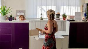 a woman standing in a store looking at herself in a mirror at Charmant camping Familiale 3 Etoiles vue 360 plage piscine à débordement empl XXL in Labeaume +148 photos
