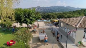 a group of people playing in a park at Charmant camping Familiale 3 Etoiles vue 360 plage piscine à débordement empl XXL in Labeaume