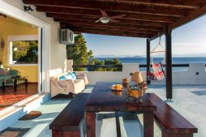 a patio with a table and a view of the ocean at Saronic Seafront in Salamina