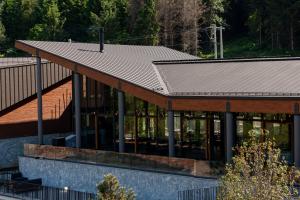a building with a metal roof on top of it at Hotel Ramonda in Boljevac