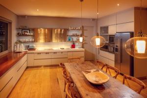 a large kitchen with a wooden table and chairs at Pringle Bay Villa by Raw Africa Collection in Pringle Bay