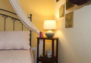 a bedroom with a bed and a lamp on a night stand at LIGURIA home in Ameglia