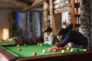two children playing with a pool table at CGH Résidences & Spas Les Clarines in Les Menuires