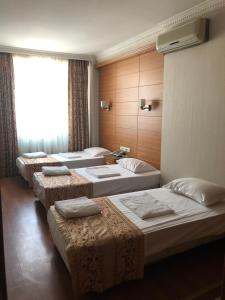 a group of four beds in a room at The Port Hotel in Istanbul