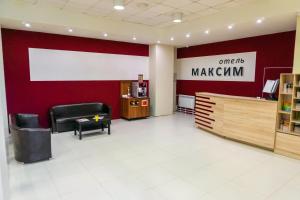 a waiting room with a red wall at Maksim Hotel in Yekaterinburg
