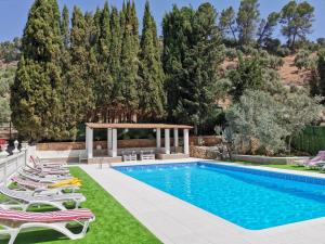 a pool with chairs and a gazebo at Casa Rural Ruiz Hernando in Villanueva del Arzobispo