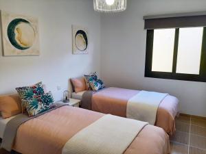 Un pat sau paturi într-o cameră la Casa Cactus